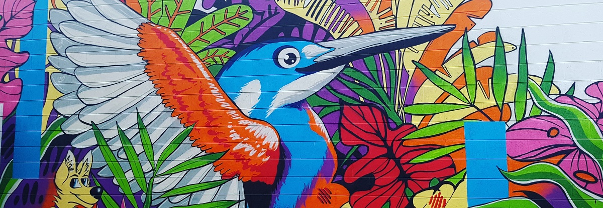 Brightly painted mural featuring a bird and foliage